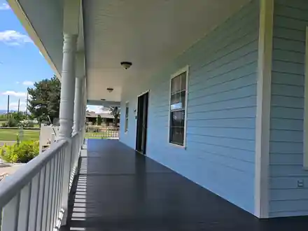 The painted porch ceiling and dark painted porch floor