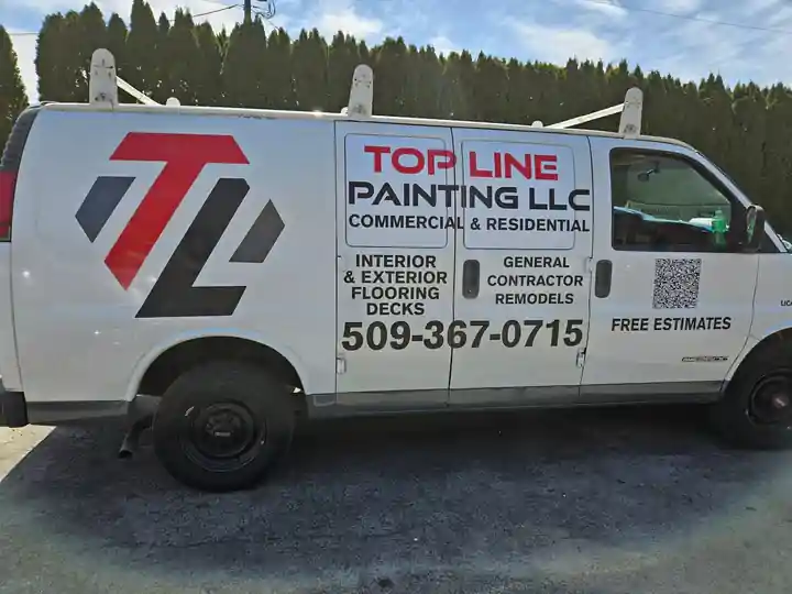 The white Top Line Painting van, lettered commercial and residential, interior and exterior, general contractor and remodels